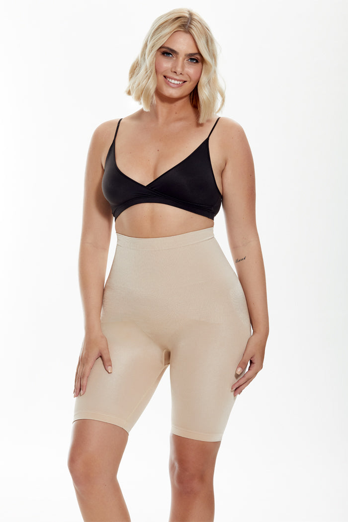 A woman in a black bralette and nude high-waisted butt lifting short, showcasing comfort and support for daily wear.