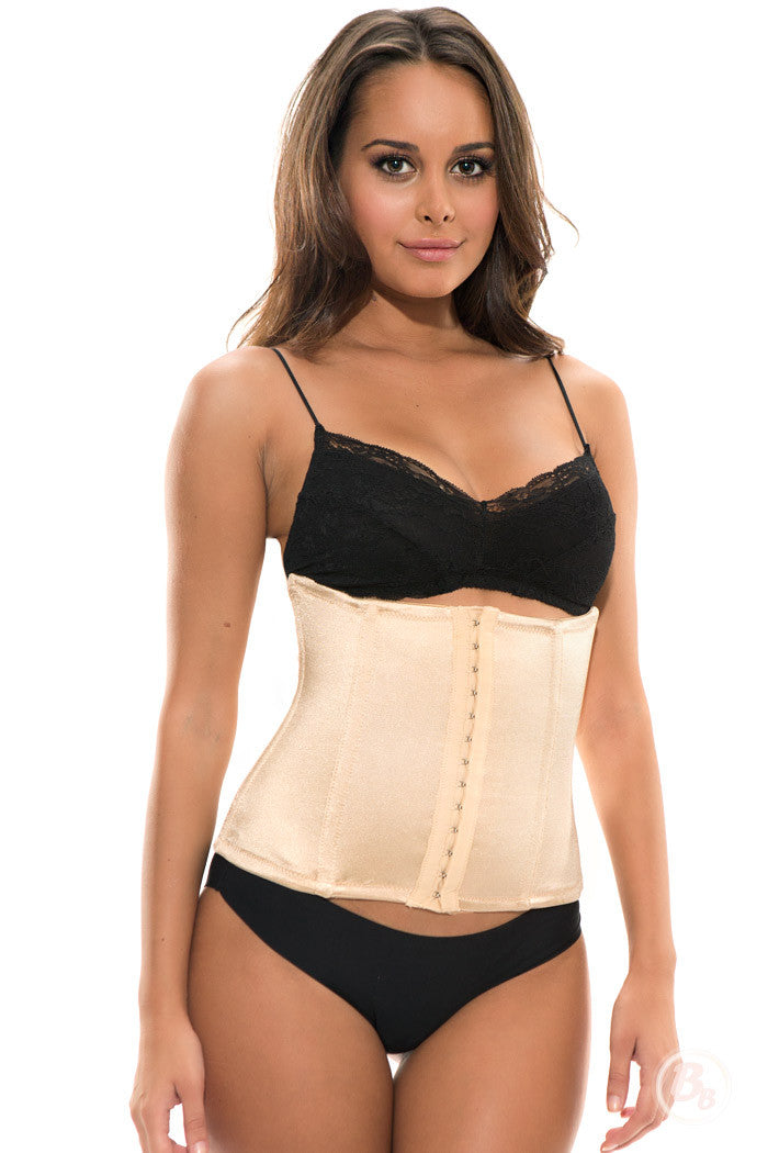Model wearing a Golden Waist Nipper, a luxurious waist cincher and shaper for hourglass figures.